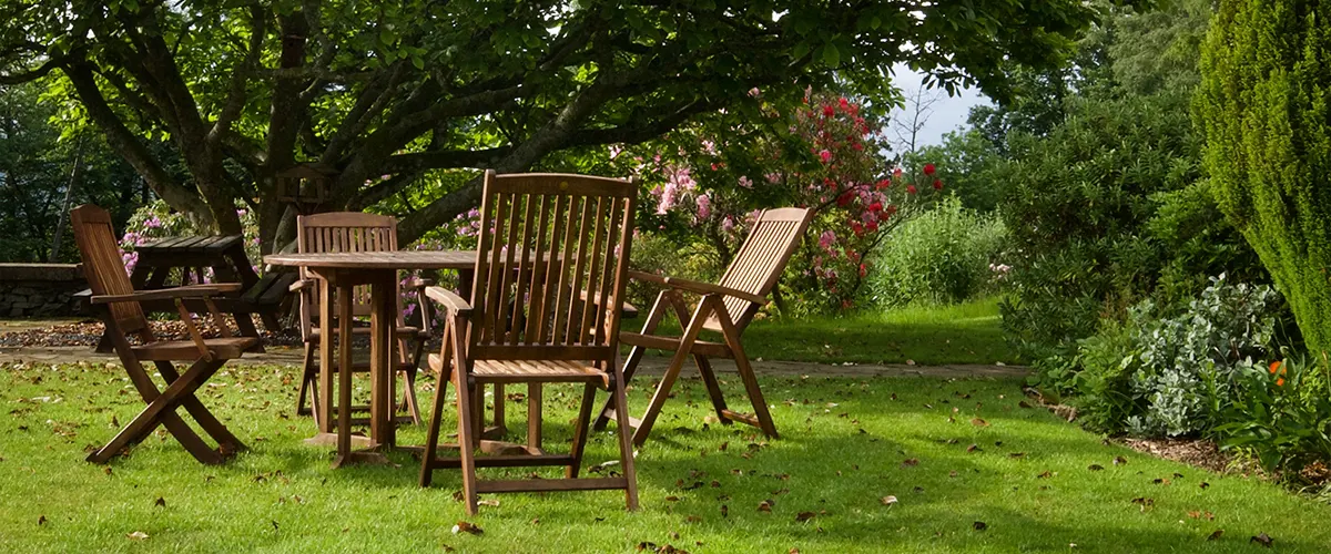 An English garden with a wood table and chairs