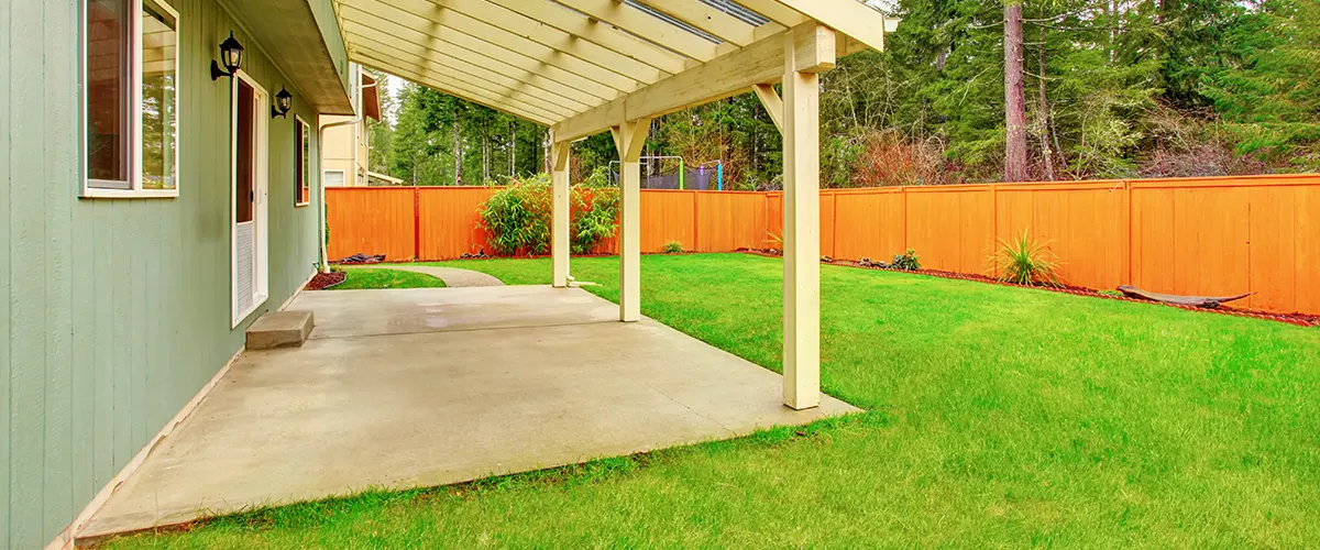 A concrete patio with a wood roof