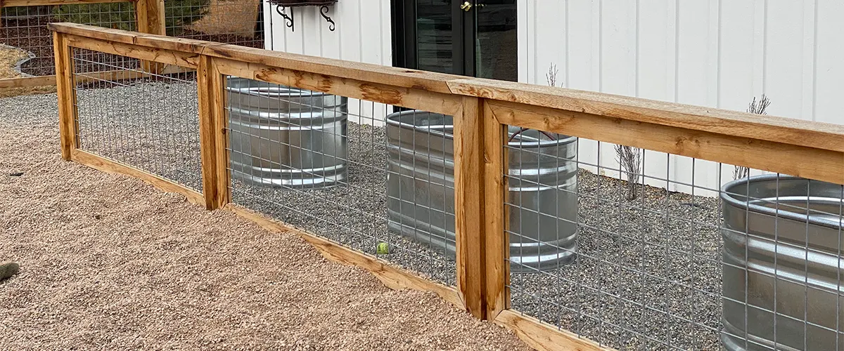 A gravel pathway with a wire fence