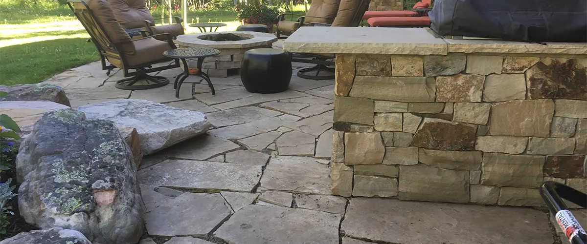 Stone seating with a fireplace and chairs