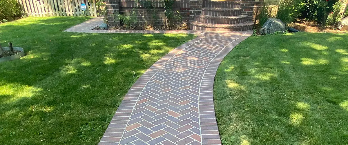 A brick pathway to a house made of bricks