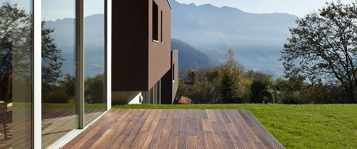 A composite deck for a modern home on top of a hill where you can see the mountain