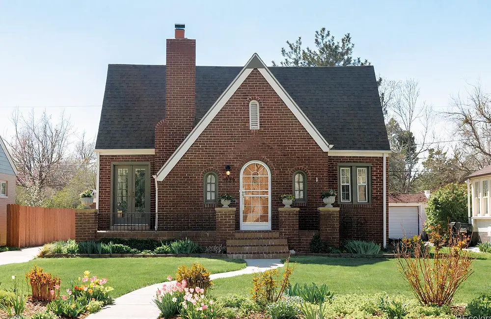 Front view of house with brick walls and beautiful, clean landscape design