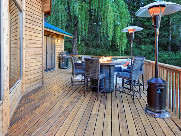 Wood deck with table, chairs, and fireplace
