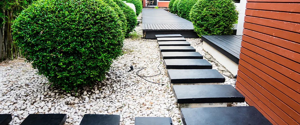 Big patio with gravel and stone and trees