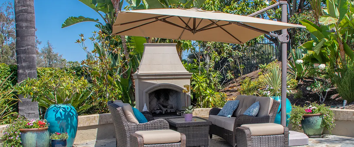 Patio with umbrella and seating areas and fireplace
