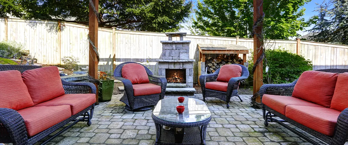 paver patio with red furniture