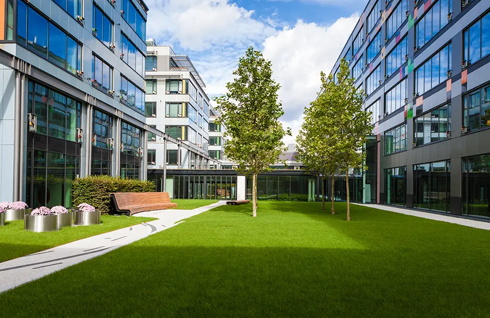 Modern office park with green lawn as part of commercial landscaping - commercial landscaping