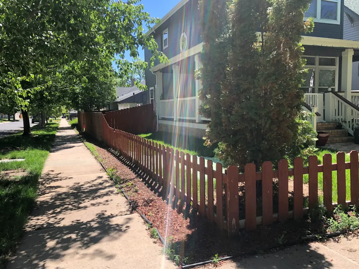 before 2 low wooden fence in Denver CO