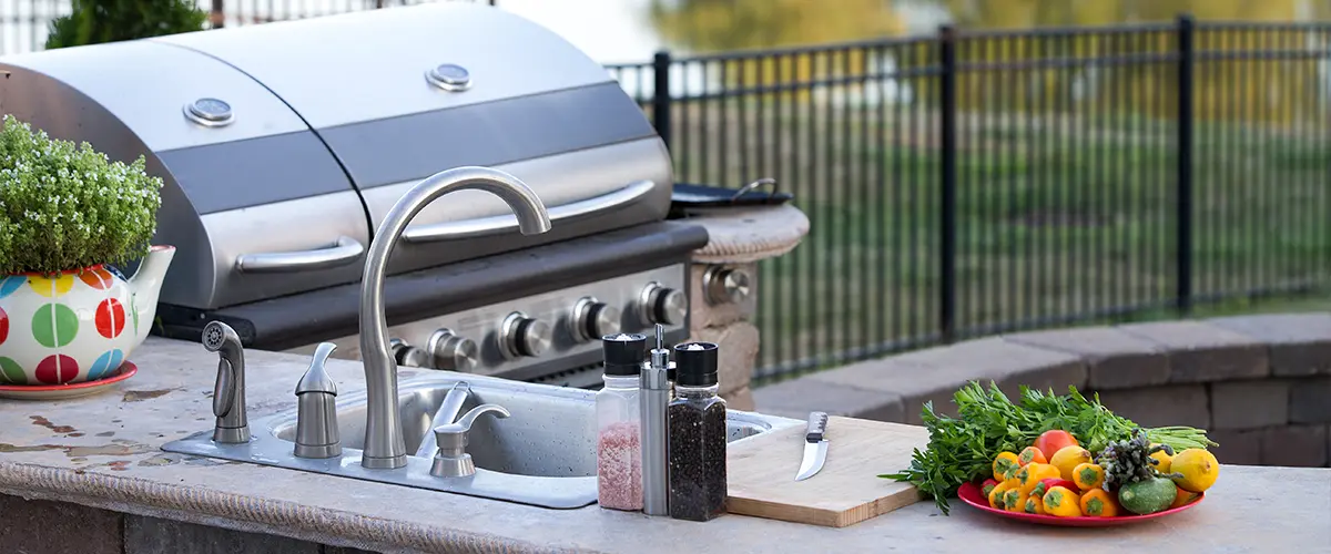 Modern grill and amenities in Outdoor Kitchens in Centennial, by serene lake.