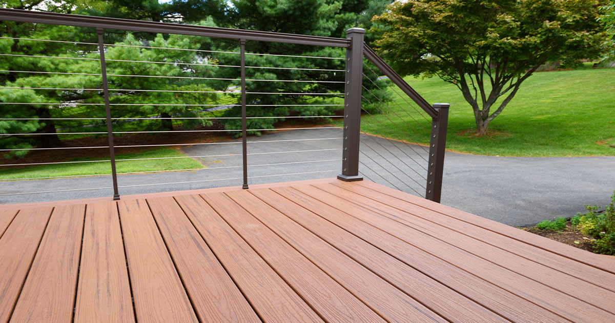 Composite deck overlooking park with green trees and walking path.