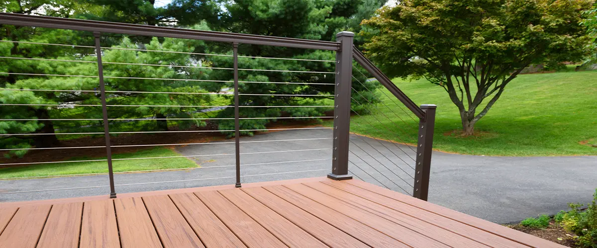 Composite deck overlooking park with green trees and walking path.