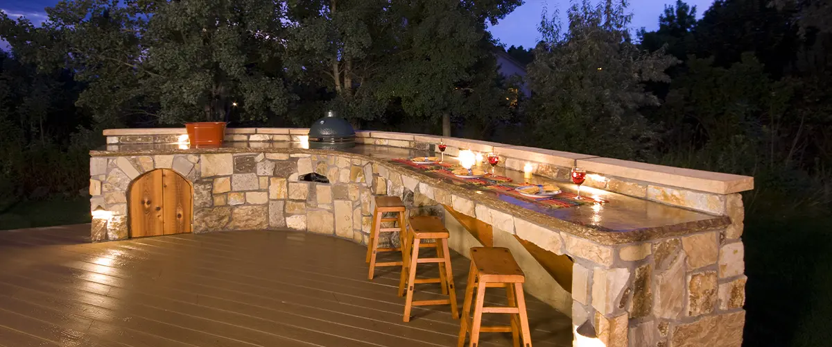 Modern outdoor kitchen with grill and seating area - Outdoor Kitchens in Lakewood, CO