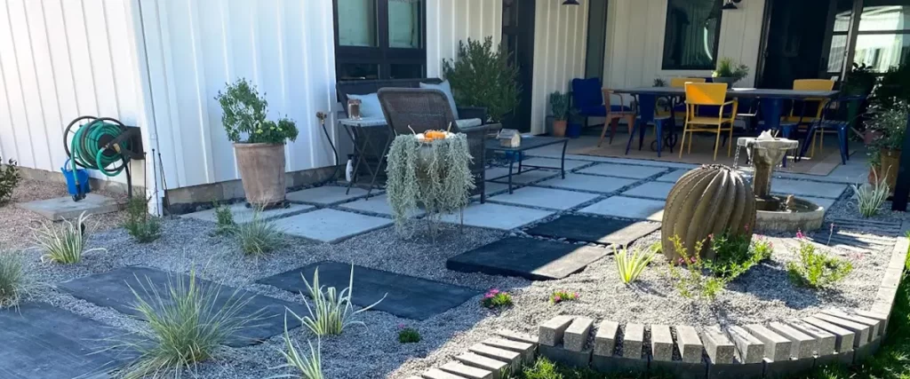 Contemporary xeriscape backyard with paver patio, outdoor seating, and water fountain landscaping design