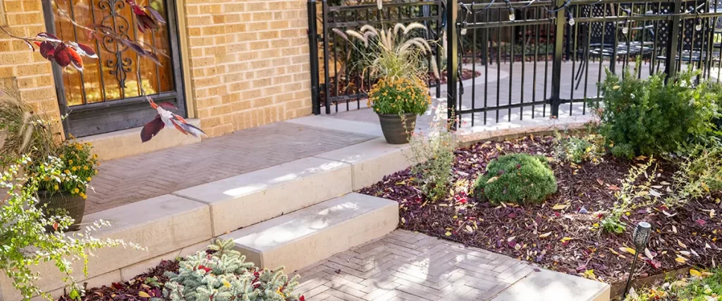 Low-maintenance xeriscape garden with mulch and native plants at a Colorado home entryway in USDA Zone 5