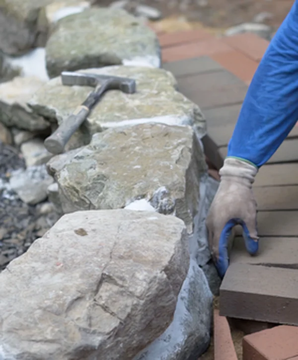 hardscaping arvada co landscaping hardscaping a professional contractor expertly places brick pavers next to natural stone