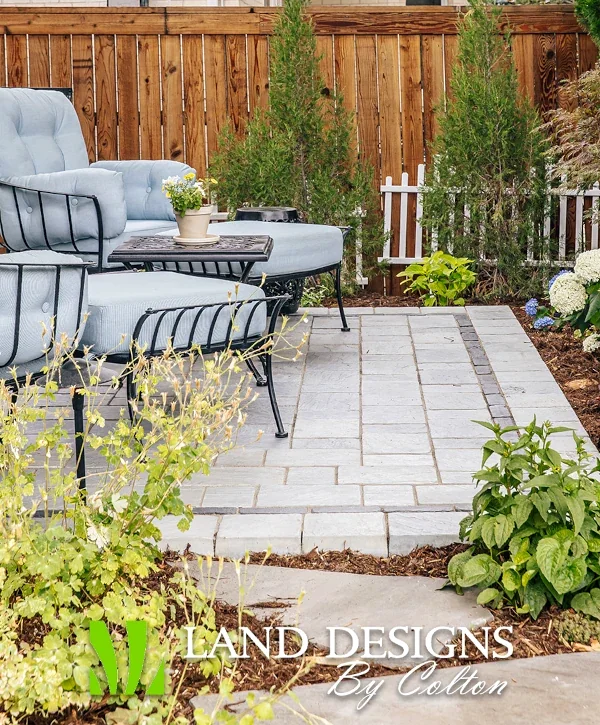 hardscaping centennial co landscaping hardscaping professional patio with blue cushioned seating stone pavers wooden privacy fence