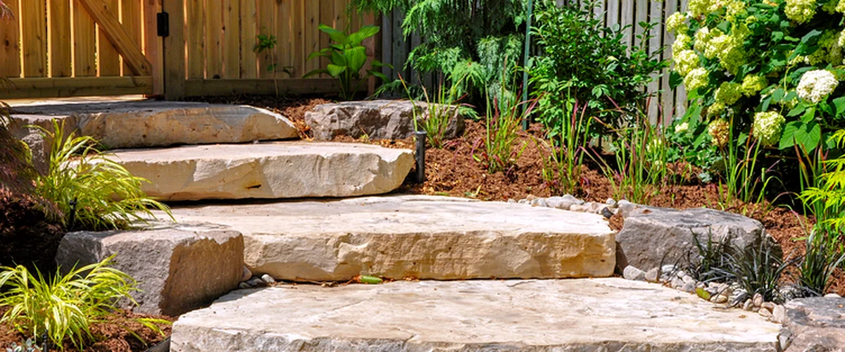 hardscaping littleton co landscaping hardscaping stone garden steps with lush greenery wooden fence and vibrant landscaping