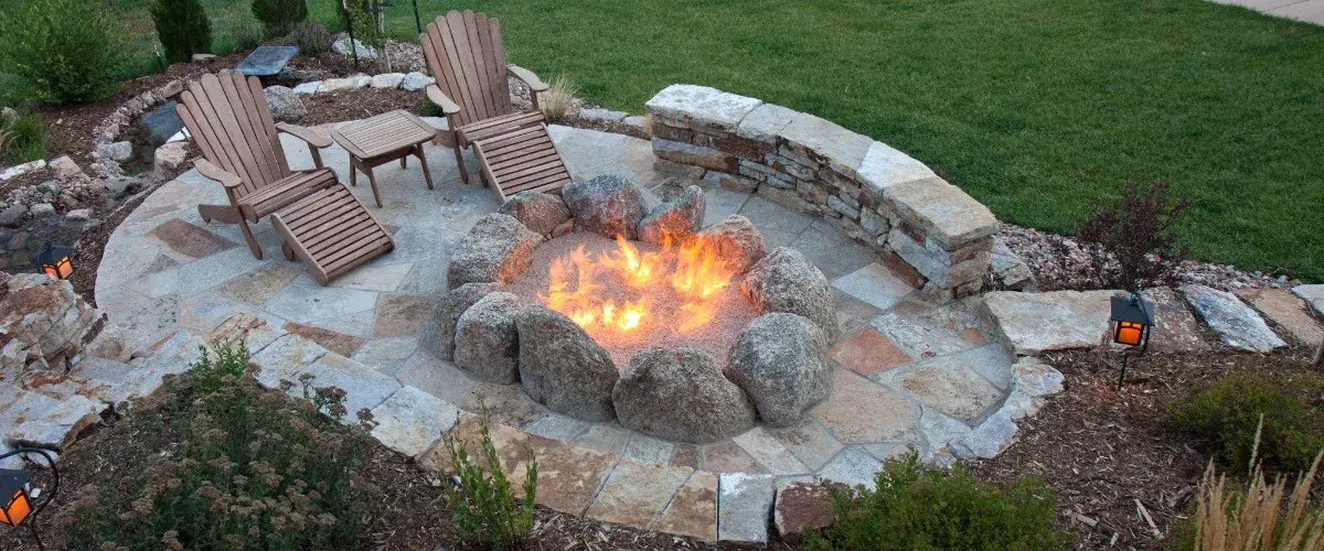 A cozy backyard fire pit surrounded by chairs, inviting for gatherings and warmth on cool evenings.