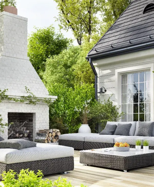 A cozy patio featuring comfortable furniture and a warm fireplace, perfect for outdoor relaxation.