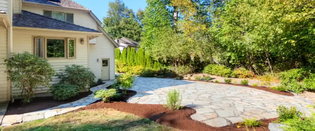 a residential house with a natural flagstone patio and walkway