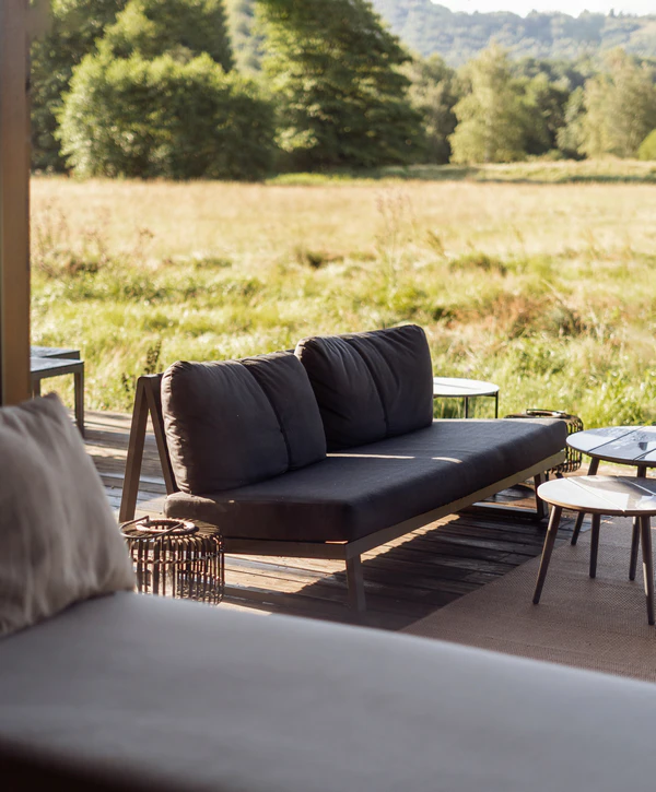 A wide-angle view of a modern outdoor living space in Dakota Ridge, CO, showing a seamless transition between indoor and outdoor areas.