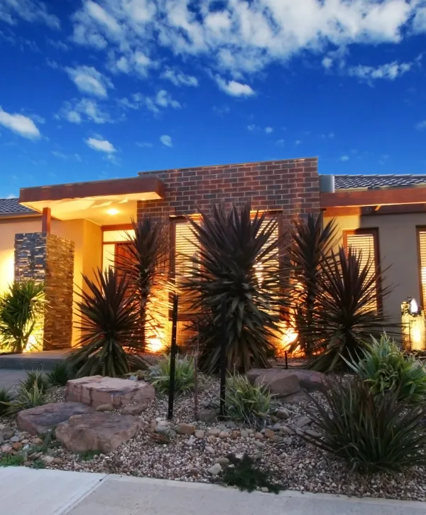 exterior of a modern home featuring contemporary landscaping design and lighting